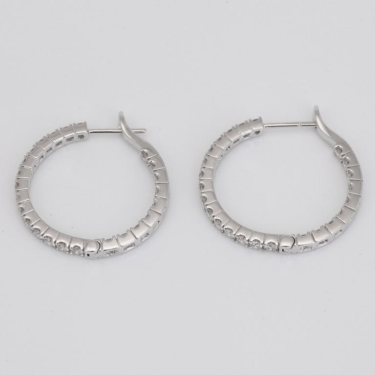 A pair of diamond, 2.303 cts according to engraving, loop earrings.