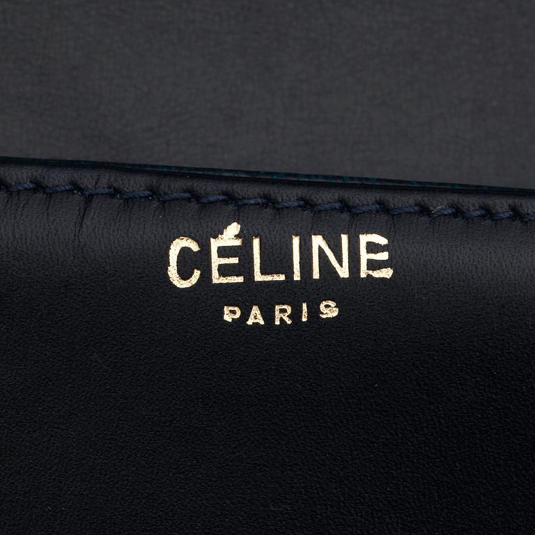 CÉLINE, a dark blue leather shoulder bag.