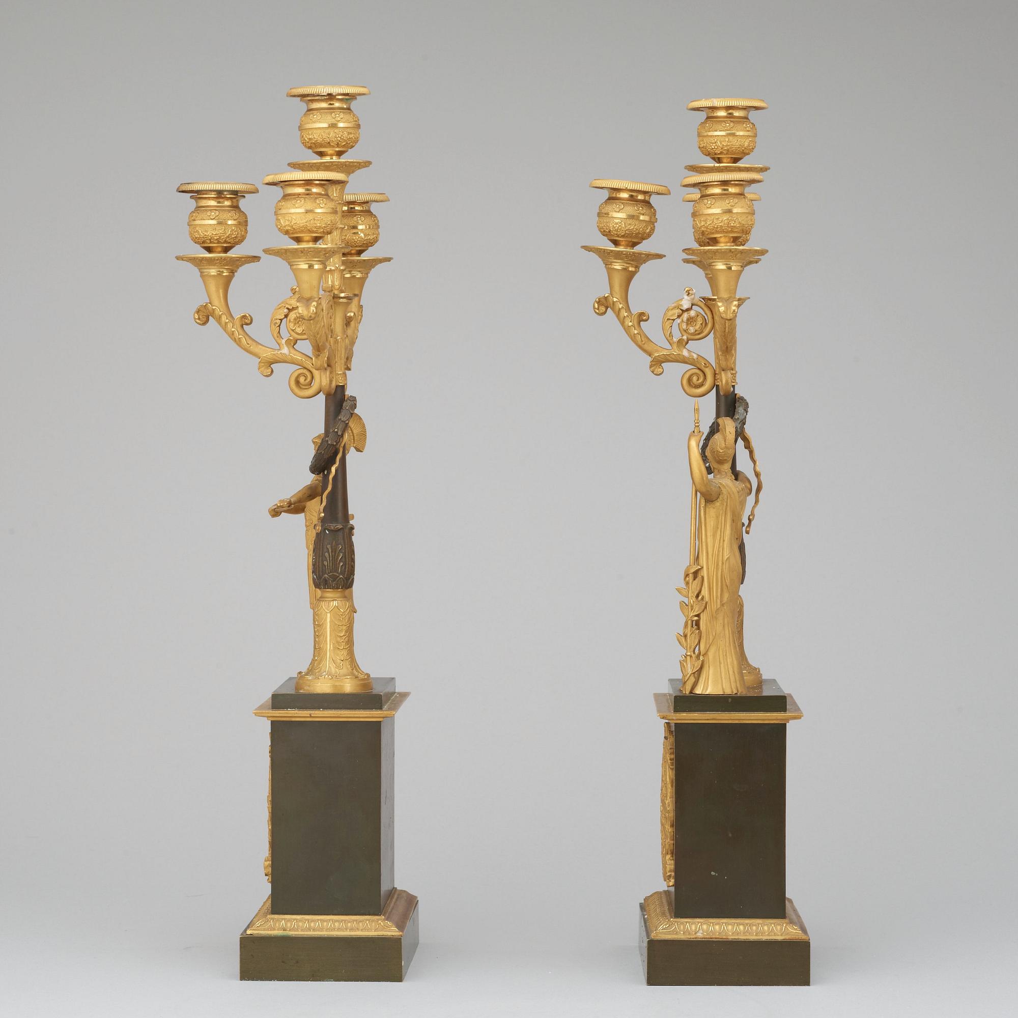 A pair of French Empire early 19th century gilt and patinated bronze four-light candelabra.