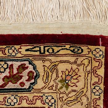 A silk and metal Hereke rug, West Anatolia, c. 58 x 39 cm.