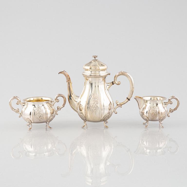 A Swedish Rococo Style Coffee Pot, Creamer and Sugar Bowl, mark of JE Skreij, Falun 1951-55.