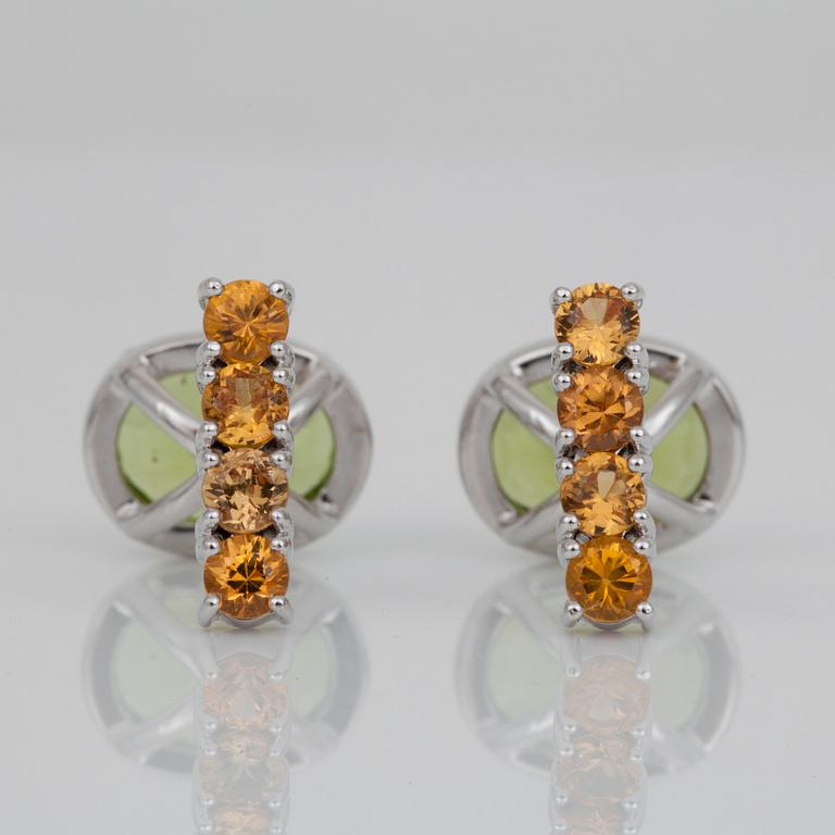 A pair of peridot and sapphire cufflinks. Peridots circa 6.10 cts and yellow sapphires circa 1.50 cts in total.