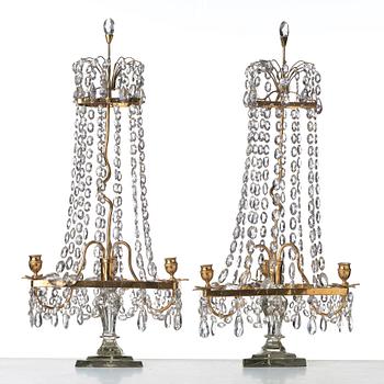 A pair of late George III late 18th century three-light table girandoles.