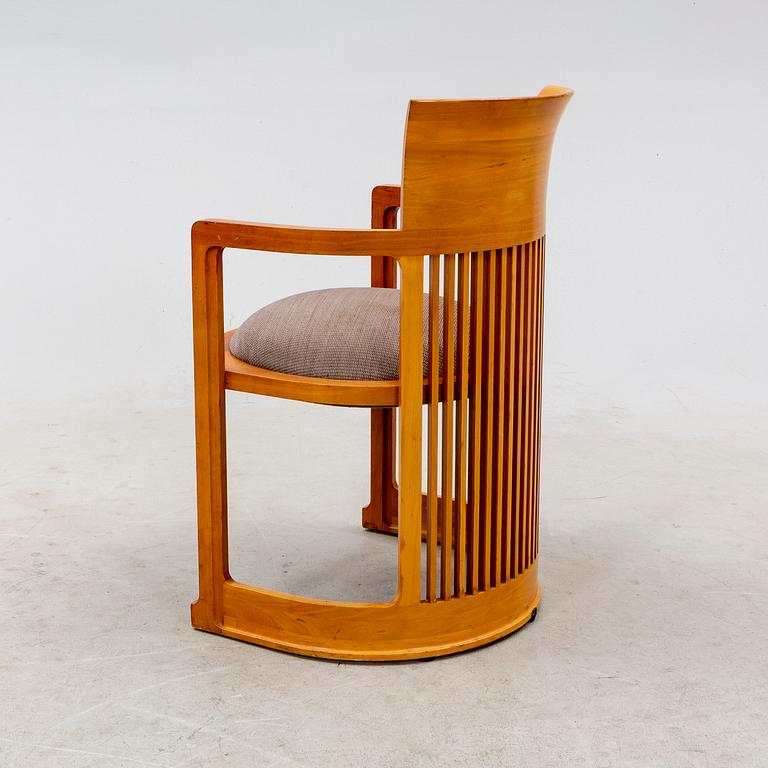 A cherry wood model 606 'Barrel' chair by Frank Lloyd Wright from Cassina.