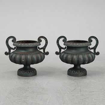 A 20th Century pair of cast iron flower pots.