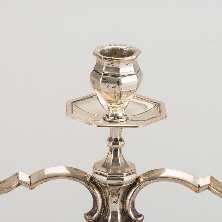 A pair of silver candelabras.