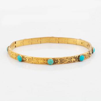 An 18K gold and turquoise cross with a chain and a 14K gold bracelet set with turquoises.