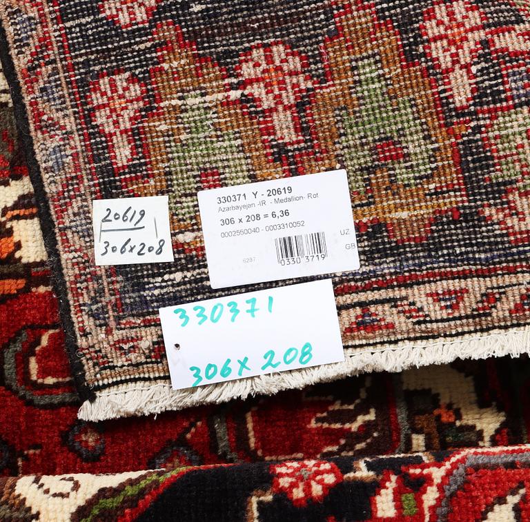 An Azerbaijan carpet, c. 306 x 208 cm.