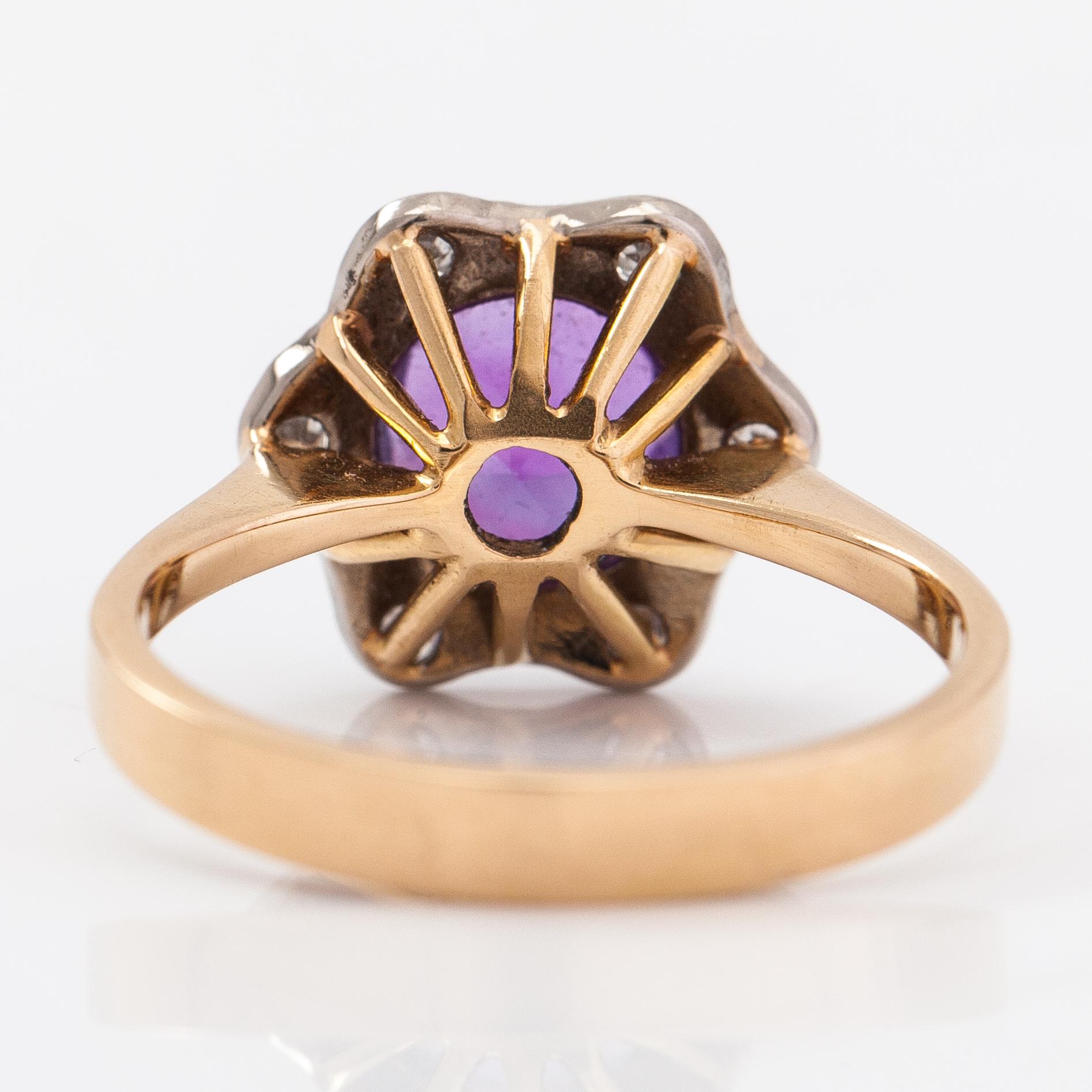An 18K gold ring with an amethyst and diamonds ca. 0.15 ct in total. H. Lahtinen & Co, Helsinki 1973.