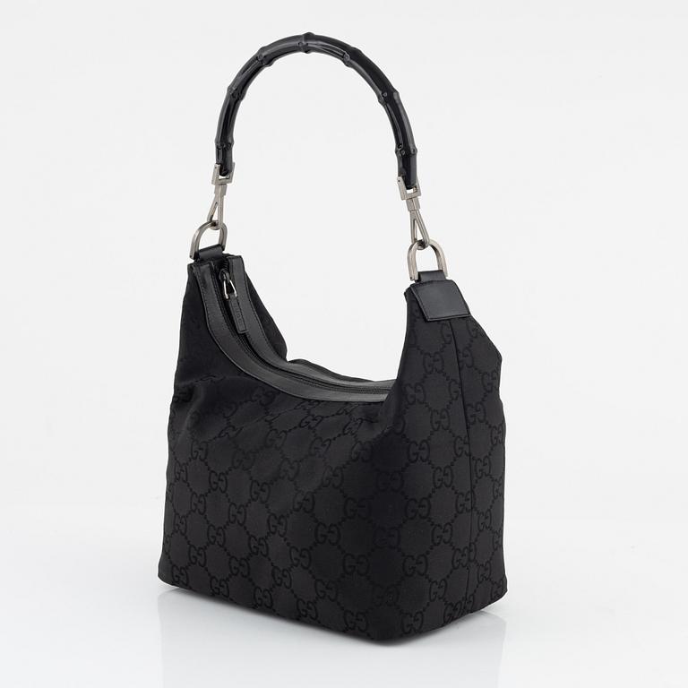 Gucci, a canvas handbag.
