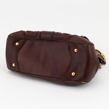 Prada, a brown leather bag.