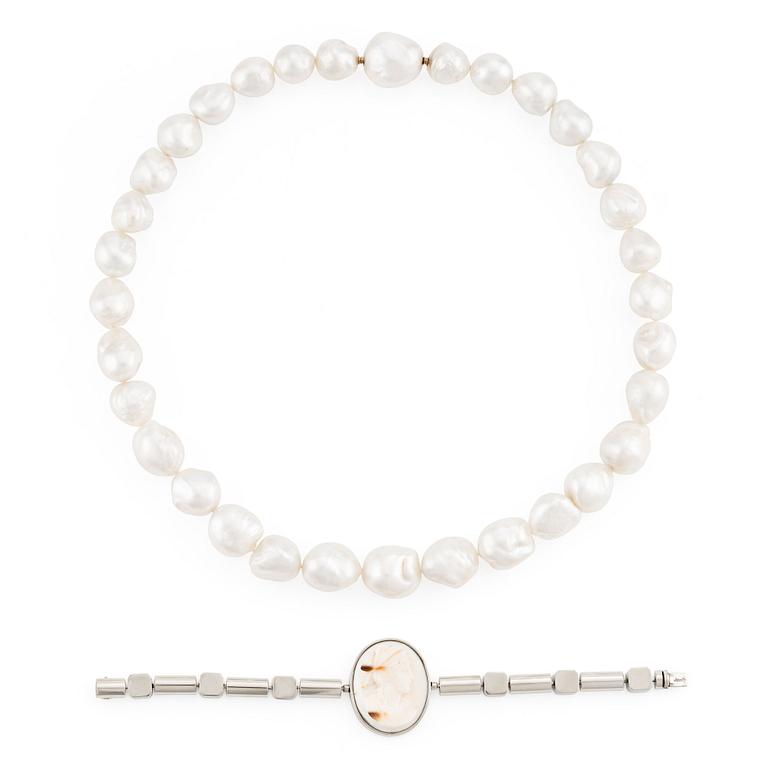 A Gaudy necklace with cultured South Sea pearls, a platinum bracelet, and two clasps.