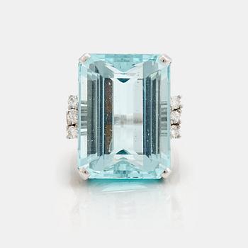 856. A emerald cut aquamarine and brilliant cut diamond ring.