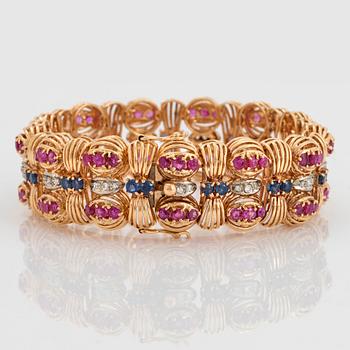 An 18K gold Bucherer bracelet set with blue and pink sapphires and round brilliant-cut diamonds.