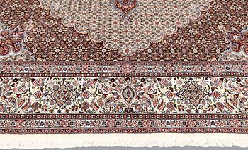 A part silk Moud carpet, approximately 350 x 252 cm.