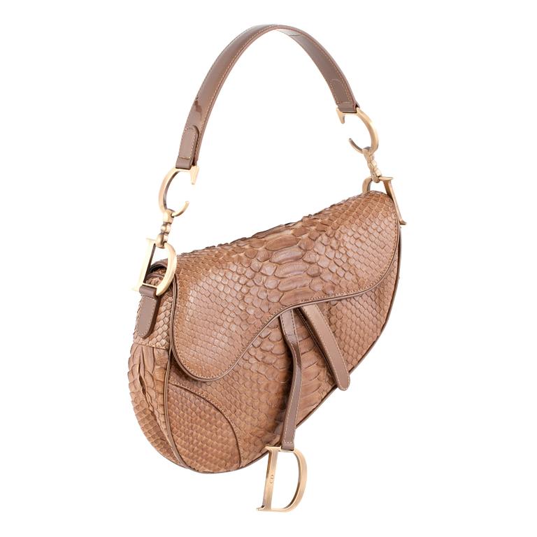 CHRISTIAN DIOR, a gold toned leather handbag, "Saddle bag".
