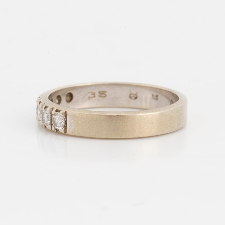 A half-eternity ring set with round, brilliant-cut diamonds.