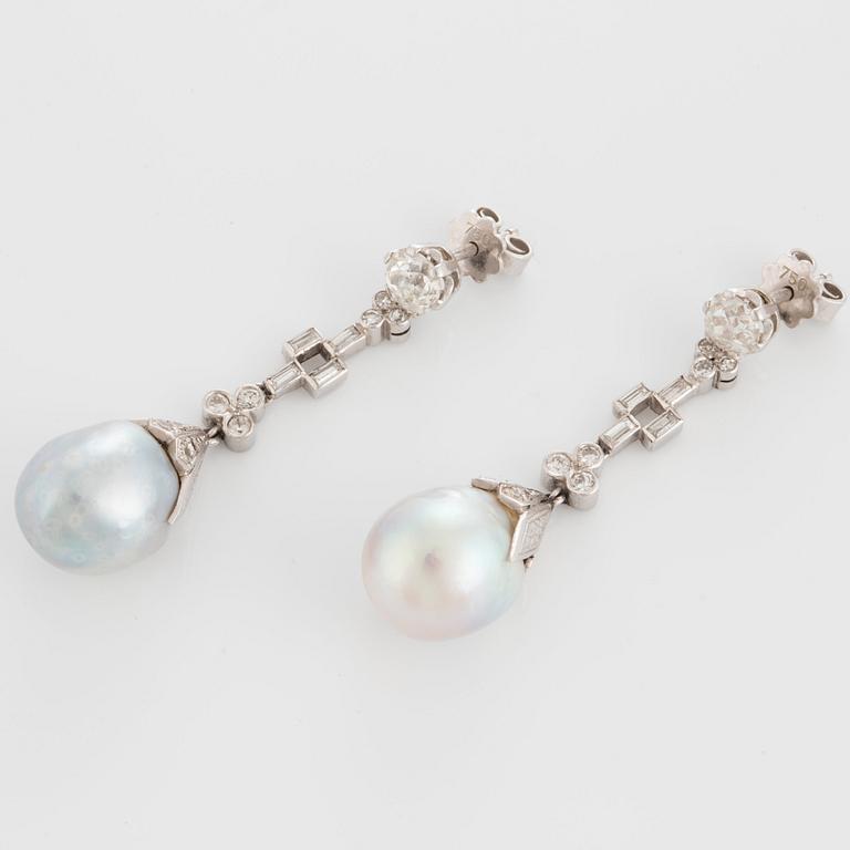 A pair of drop-formed pearl earrings in a box from Cartier.