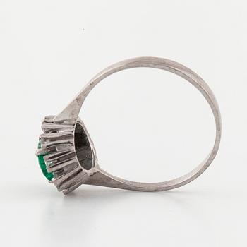A emerald and brilliant cut diamond ring.