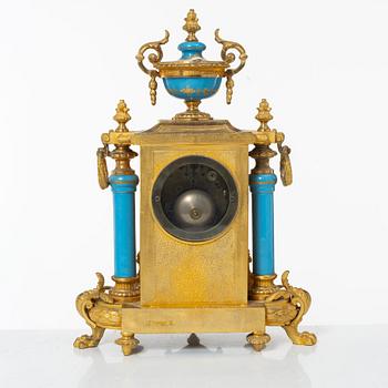 A French Louis XVI-style mantel clock and a pair of candelabra, late 19th Century.