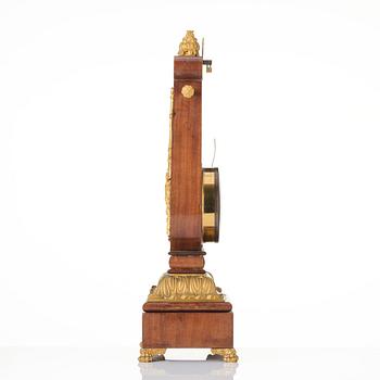 A French Empire mahogany, ormolu and gilt metal lyre-shaped mantel clock, early 19th century.