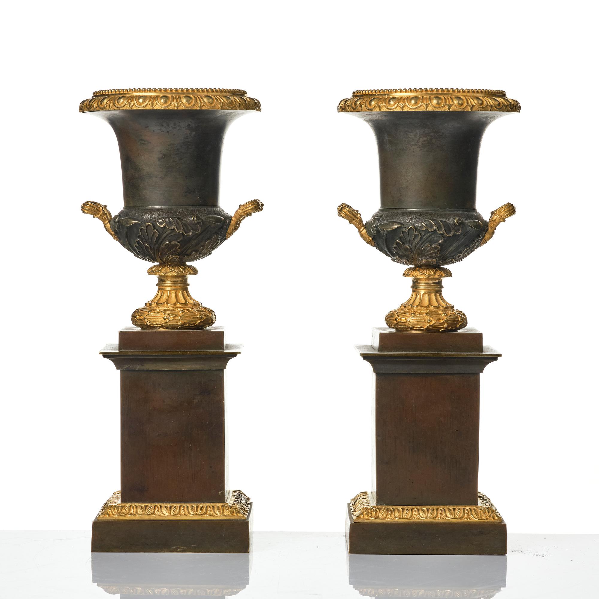 A pair of French Louis Philippe gilt and patinated bronze urns, first part 19th century.