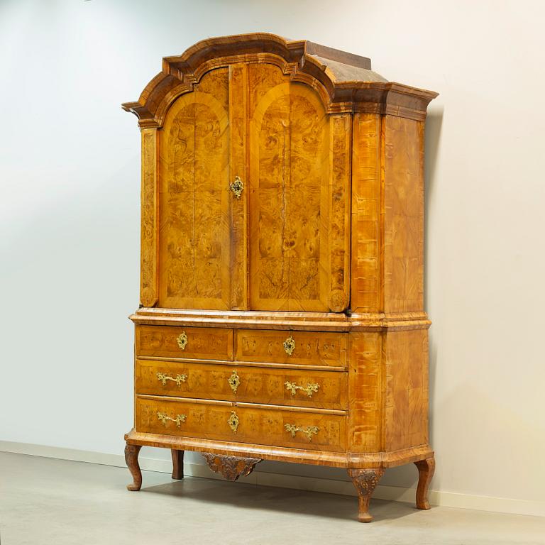 A Swedish elm and burr-elm rococo cabinet, later part of the 18th century.