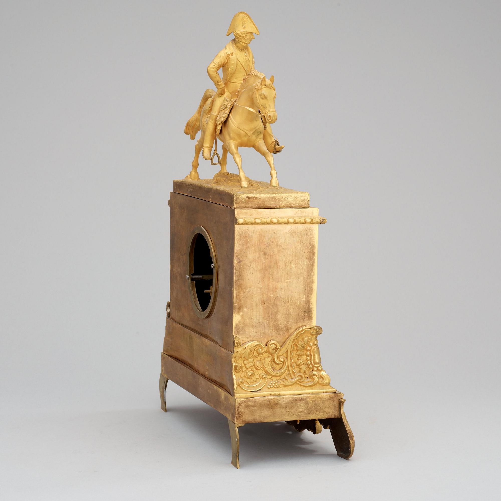 A Swedish Empire Equestrian gilt bronze mantel clock depicting king Karl XIV Johan.