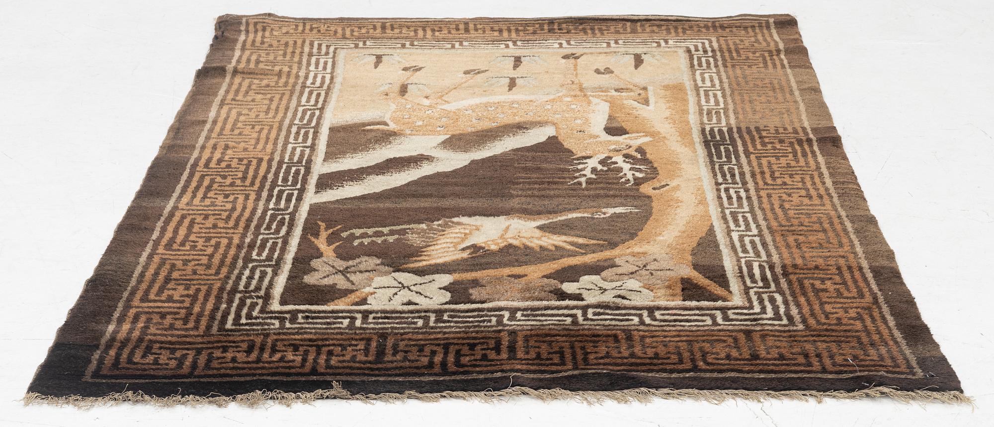 A figural semi-antique rug, China, c. 169 x 117 cm.