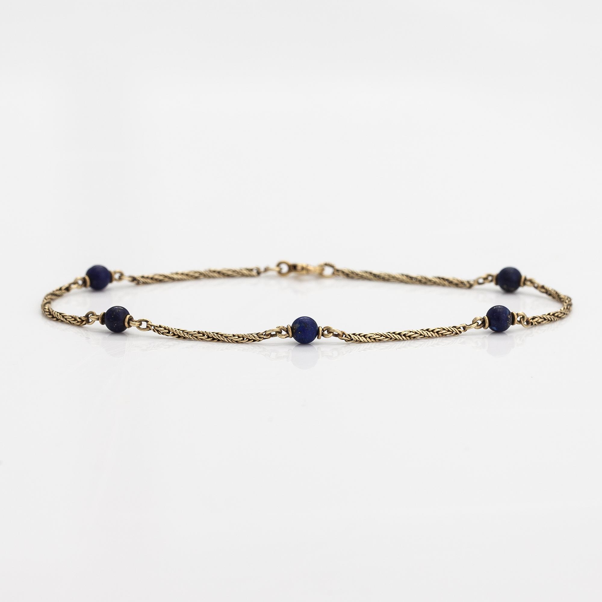 A 14K gold bracelet with lapis lazuli.
