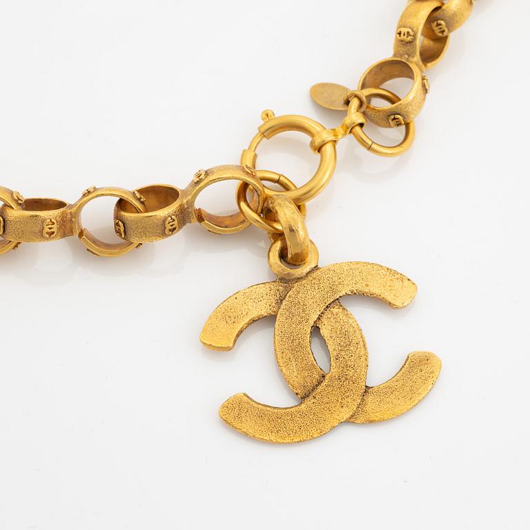 Chanel, a gold tone chain/belt.