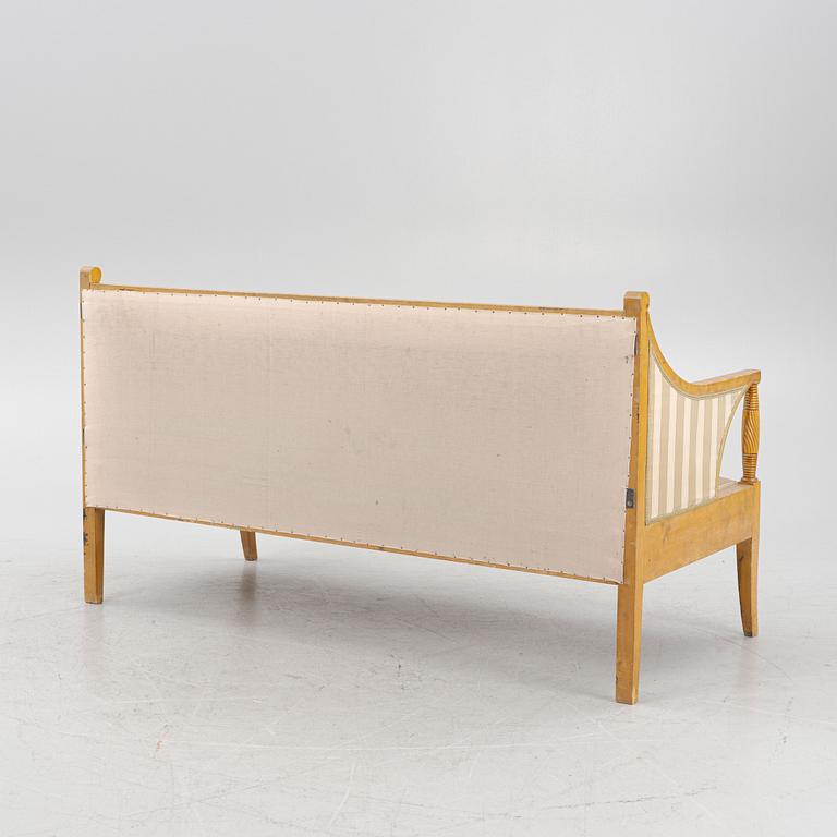 A birch sofa with two armchairs, four chairs and two stools and a mahogany center table.