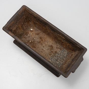 A cast iron plant pot, 20th Century.