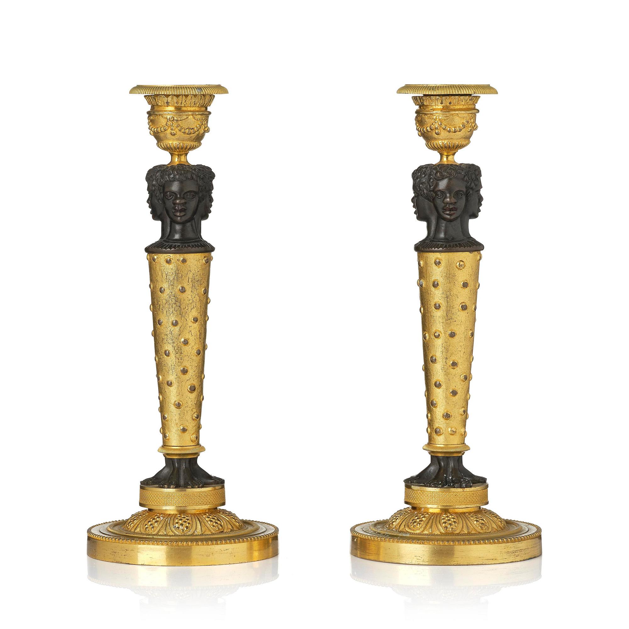 A pair of Napoleon III gilt and patinated bronze candlesticks, later part 19th century.