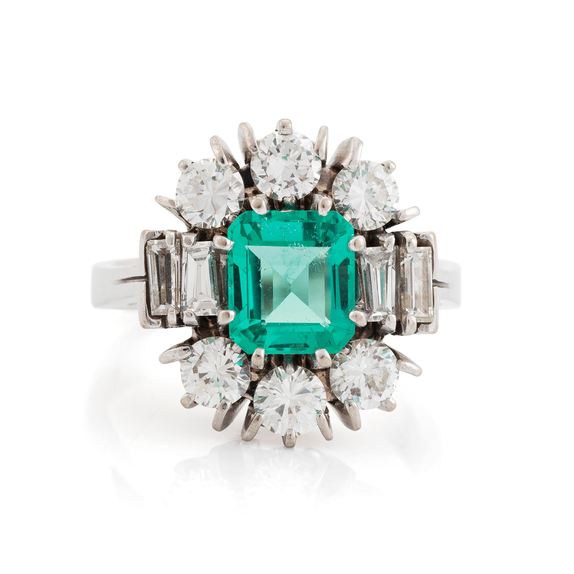 An 18K white gold ring set with a step-cut emerald.