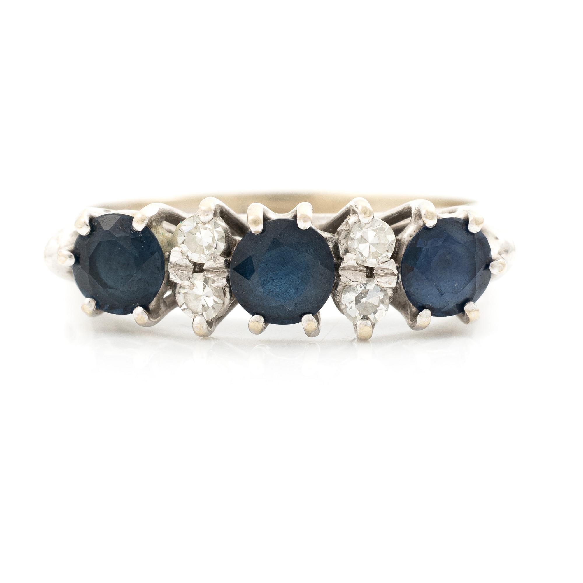 Ring, 18K white gold, set with three sapphires and single-cut diamonds.