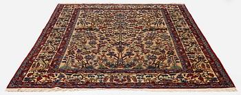 A semi-antique Qum carpet, Central Persia, c. 312 x 215 cm.