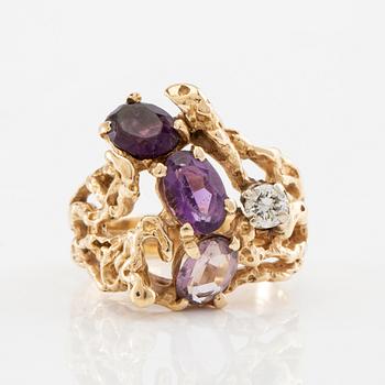 14K gold ring with amethysts and a round brilliant-cut diamond.