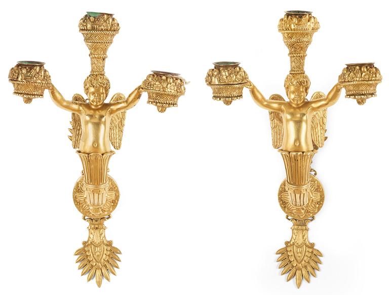 A pair of Empire early 19th century three-light wall-lights.