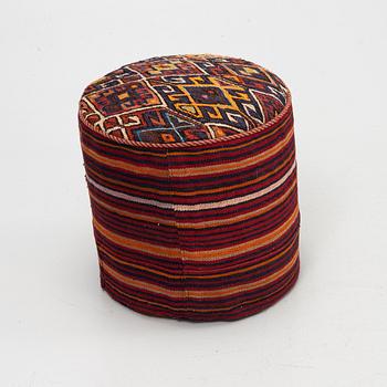 A Kelim covered stool.