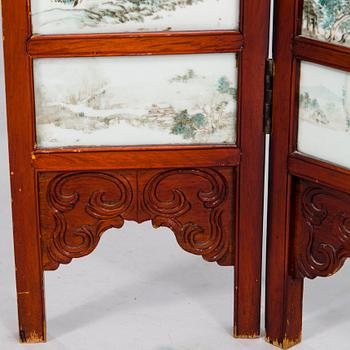 A Chinese folding screen with 48 porcelain tiles, late Qing dynasty, signed Ren Huanzhang, and dated 1881.