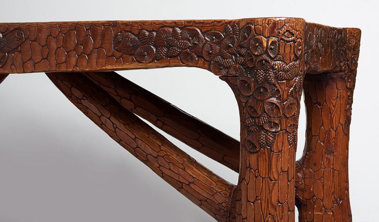 Gustaf Fjaestad, an Art Nouveau carved pine table, Arvika Sweden 1914, a double to the table in the Thiel Collection,
