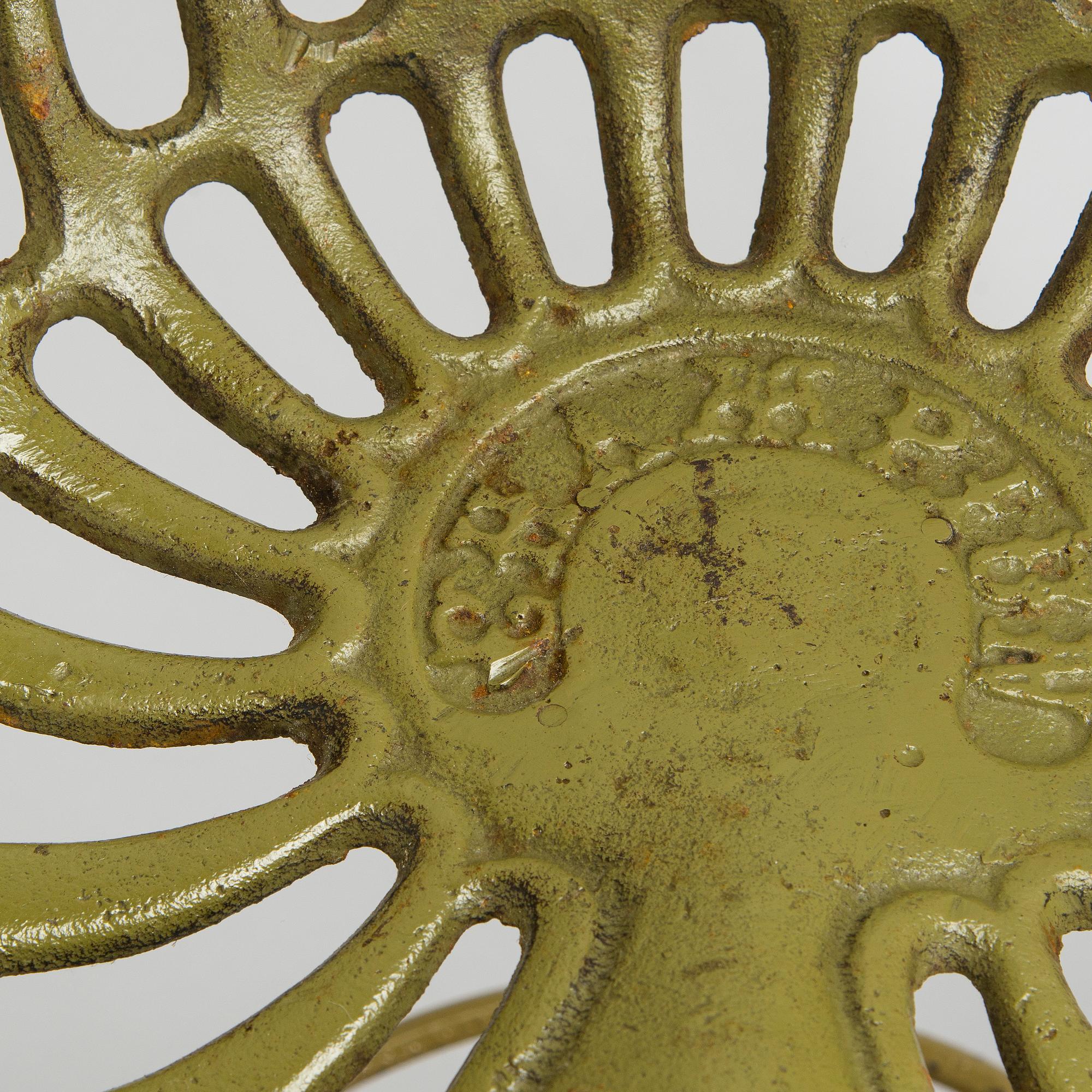Four bar stools, painted cast iron, partly from the early 20th century.