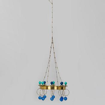 Kaija Aarikka, A 1960s/1970s brass mobile candelabra by Aarikka with candles by Timo Sarpaneva.