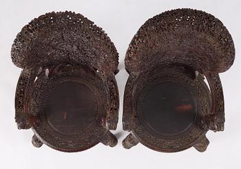 A pair of carved 'blackwood' armchairs, Bombay presidency, British Raj, circa 1880.