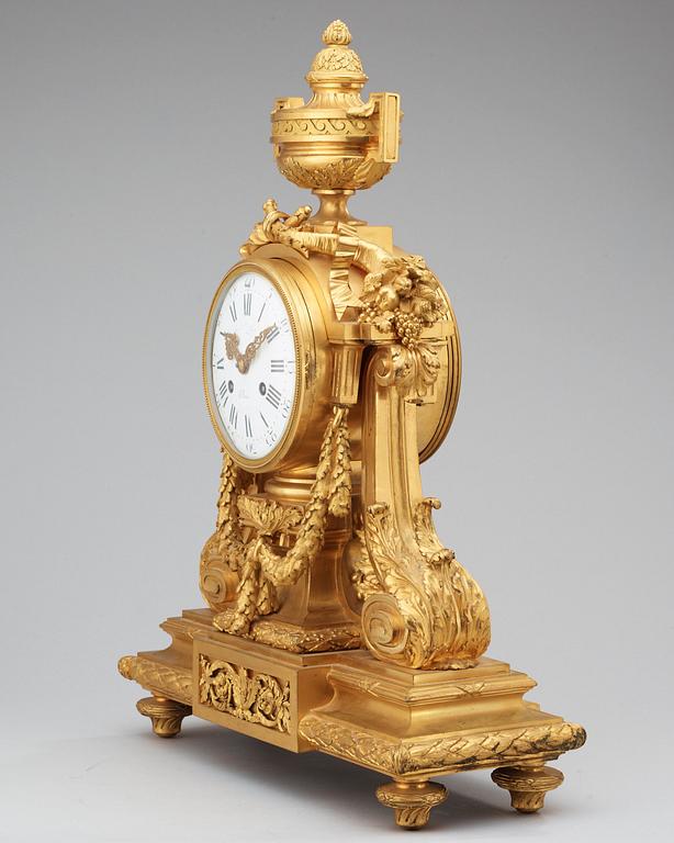 A Louis XVI-style late 19th Century gilt bronze mantel clock.