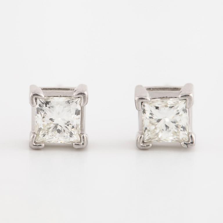 A pair of princess cut diamond earrings.