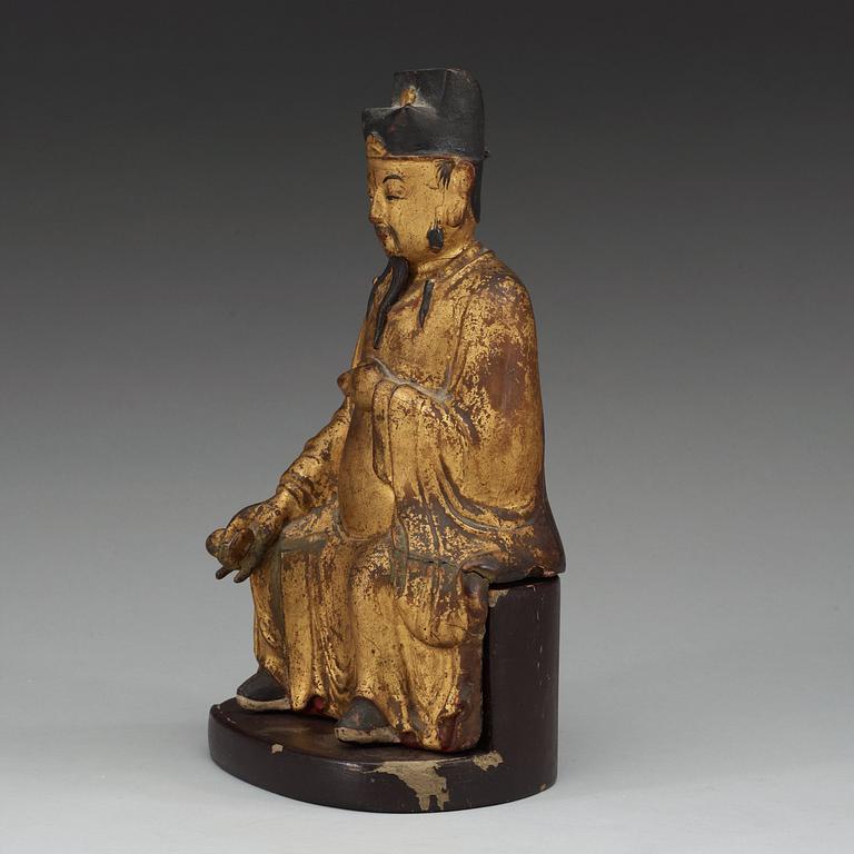 A gilt and lacquered wooden figure of a deity, Ming style.