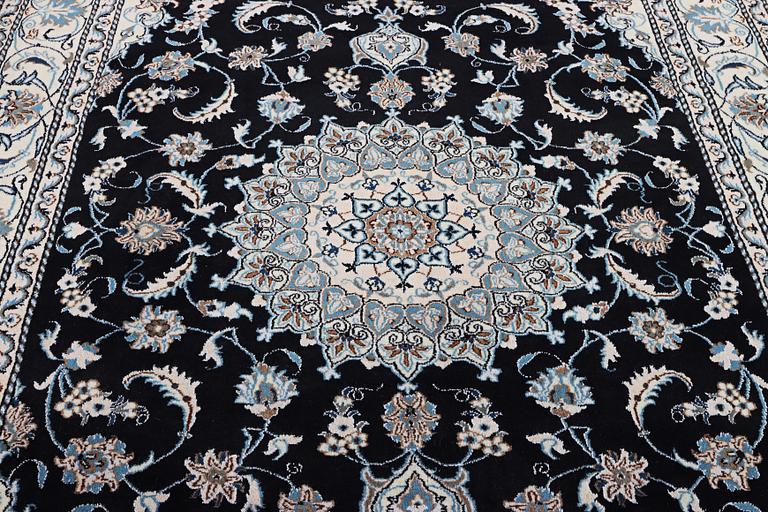 A Nain carpet, part silk, c. 286 x 206 cm.