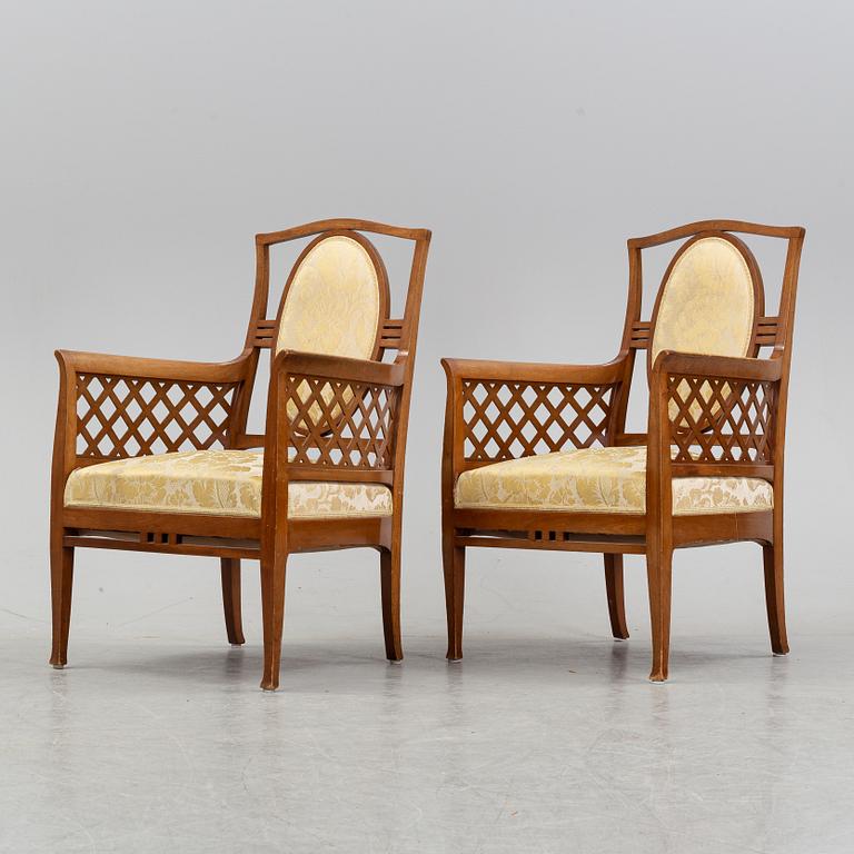 A mahogany sofa, with two armchairs and a round table, early 20th Century.